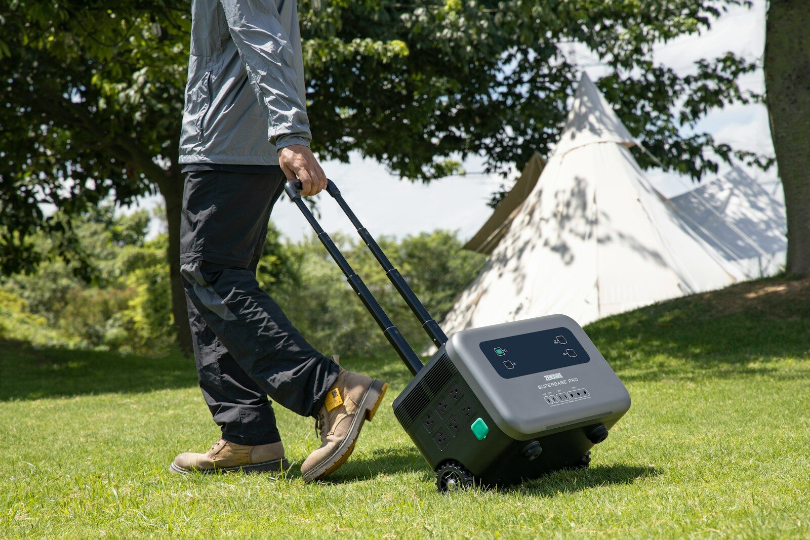 A portable power station being wheeled across a campsite, demonstrating simple power options for car camping.